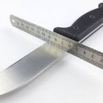 Using a straight-edge to confirm the primary bevel type.