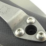 The clip has a hole to provide access to the pivot screw or lanyard hole depending on where you fit it.