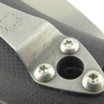 The clip has a hole to provide access to the pivot screw or lanyard hole depending on where you fit it.