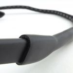 The rubber tube of the neck strap is pushed over the end of the arm.