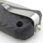 A short pocket clip is held in place with a glass breaker tipped bolt.