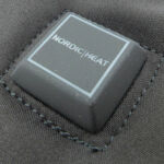 On the back of the wrist is the power button.