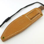 The belt loop is integral to the main body of the sheath.
