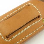 Stitching outlines the backing piece which prevents the knife coming through the belt loop slots.