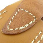 The folded over belt loop is stitched onto the back of the sheath.