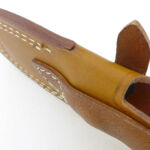 The front and back of the sheath (and the belt loop) are all a single piece of leather with a couple of folds.
