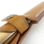 The retention strap sits tightly round the handle and the finger guard cannot get past it.