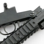Pushing a little harder and the lever will move and allow the rifle to fold a little further.