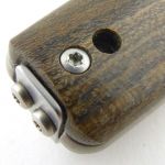 A Torx handle screw and the lanyard hole.