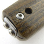 A Torx handle screw and the lanyard hole.