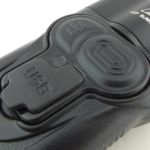 A rubber part houses two switches and the charging port cover.